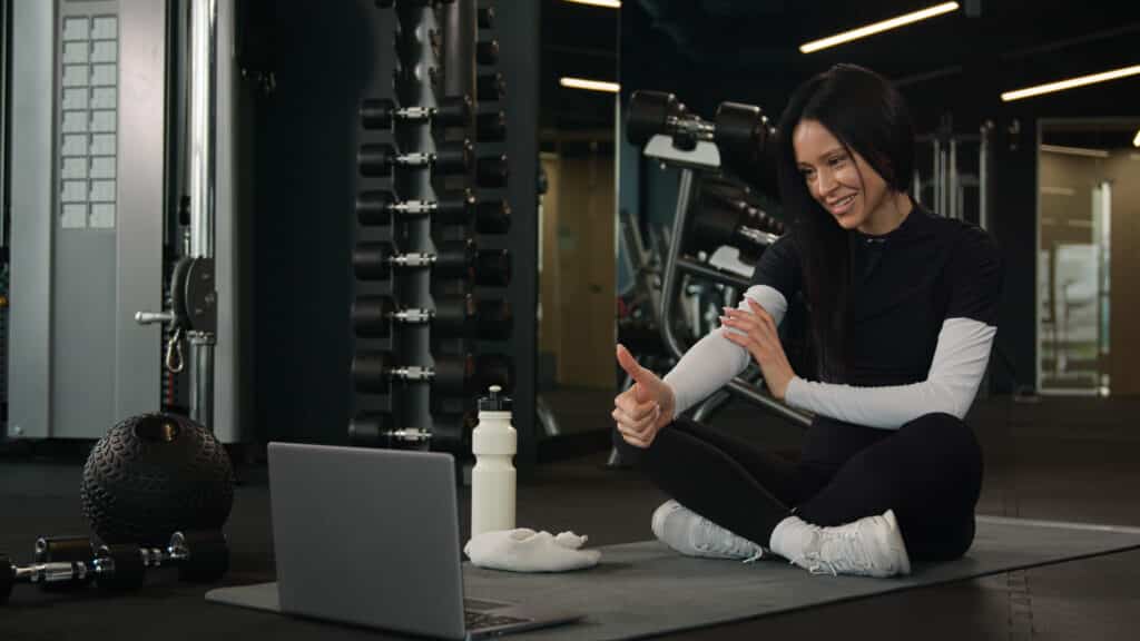 Professional fitness trainer woman teaching an online class.